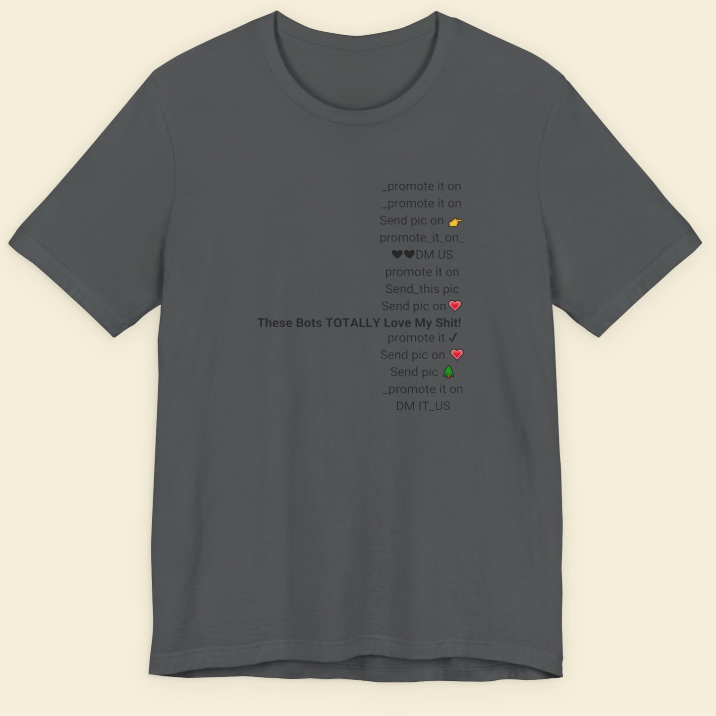 Gray t-shirt with text and emojis on a beige background.