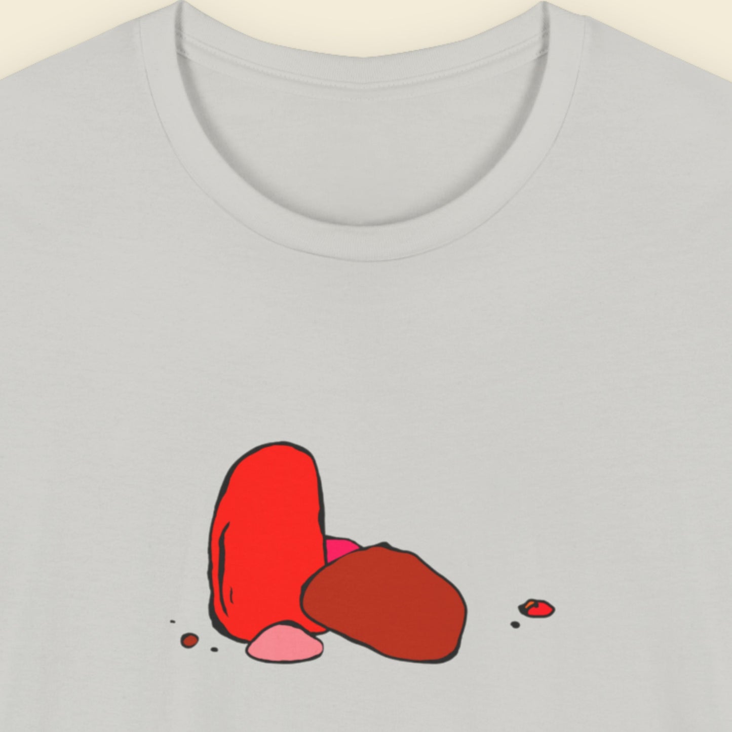 Grey t-shirt with a colorful drawing on a beige background.