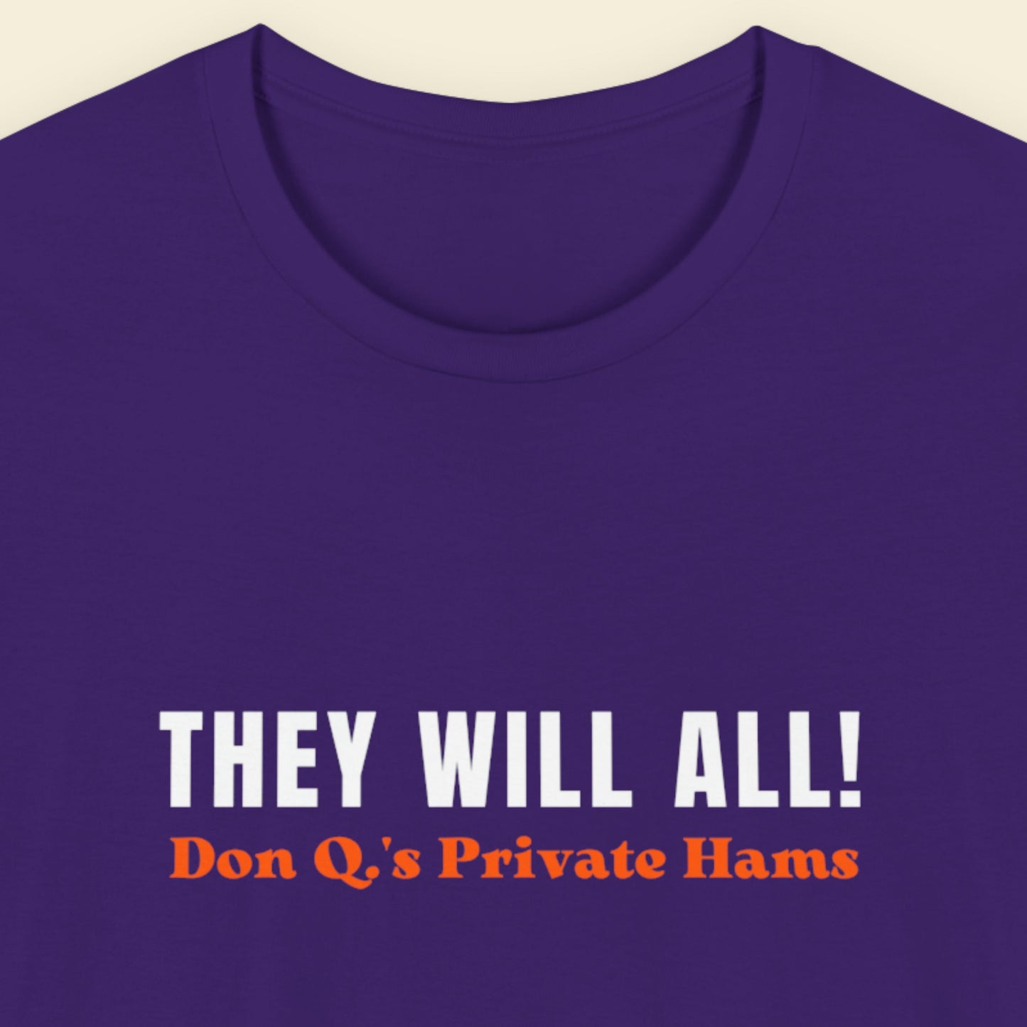 Purple t-shirt with text 'THEY WILL ALL! Don Q's Private Hams' on a beige background.