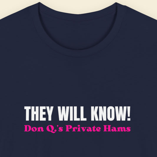 Navy blue t-shirt with white and pink text on a beige background.