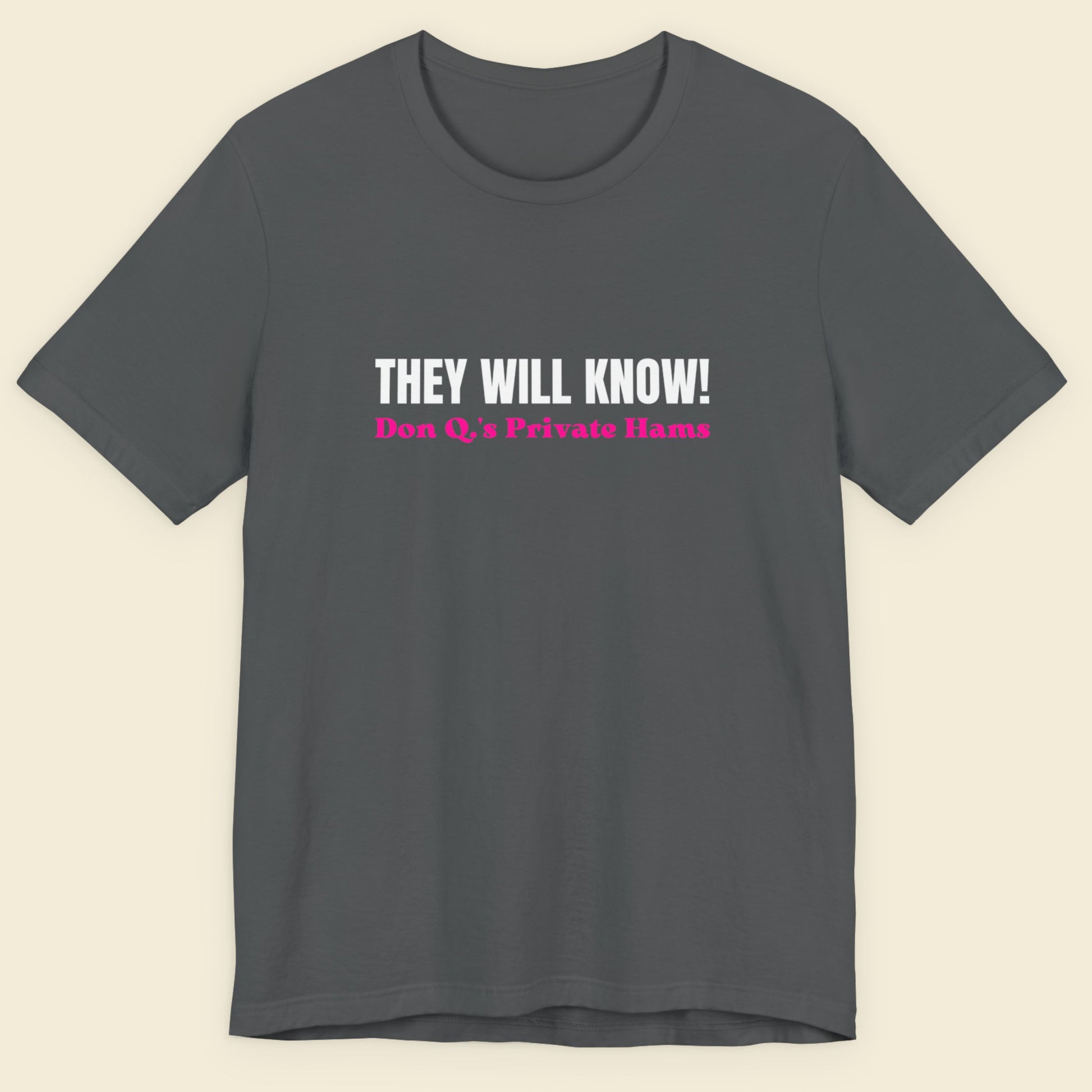 Gray t-shirt with text on a beige background.