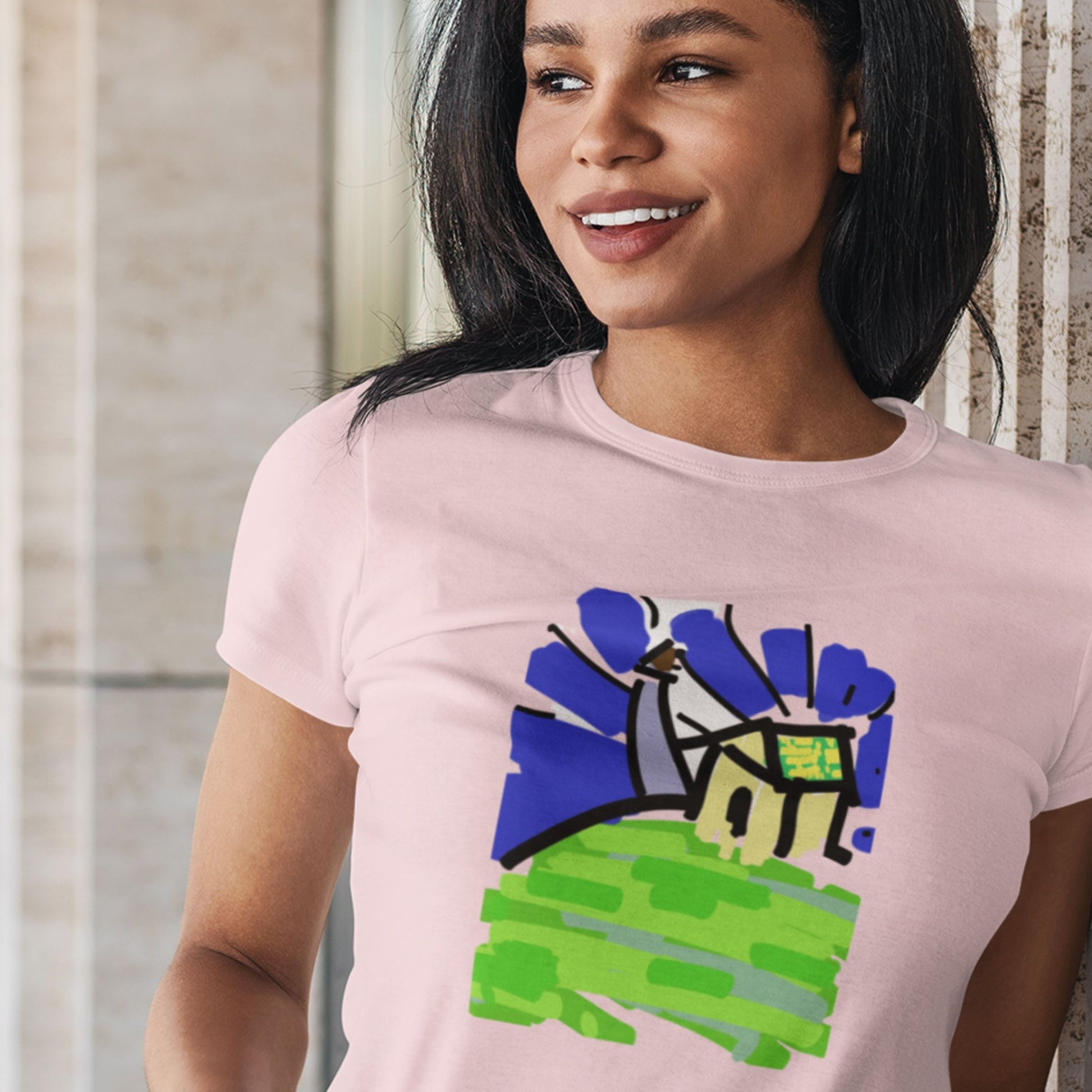 Person wearing a pink t-shirt with a colorful graphic design.