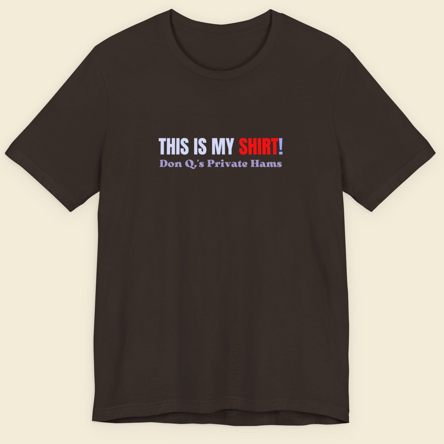 Brown t-shirt with multicolored 'THIS IS MY SHIRT!' text on a beige background.