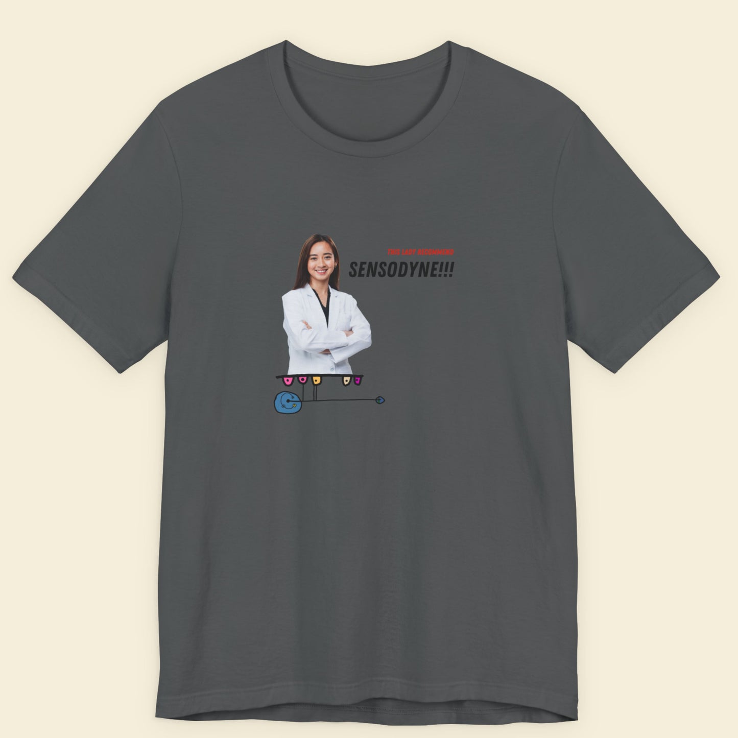 Grey t-shirt with a colorful abstract drawing, humorous text and an image of a dentist on a beige background.