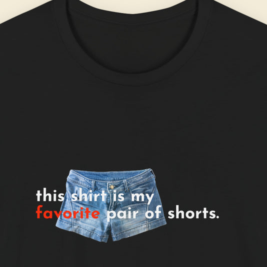Black t-shirt with denim shorts graphic and text on a beige background.