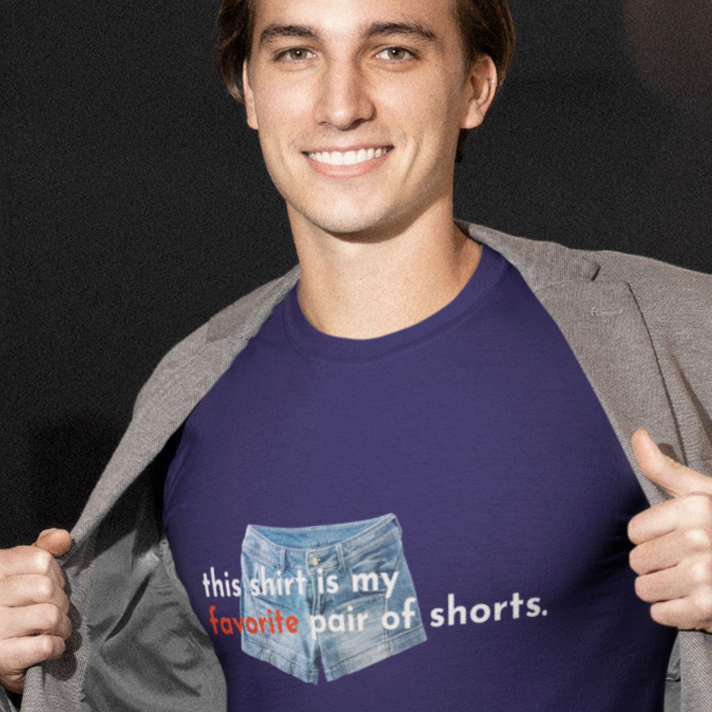 Man wearing a navy blue t-shirt with text and denim graphic, giving a thumbs-up.