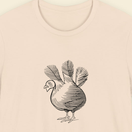 Beige shirt with a sketch of a three tailed chicken.