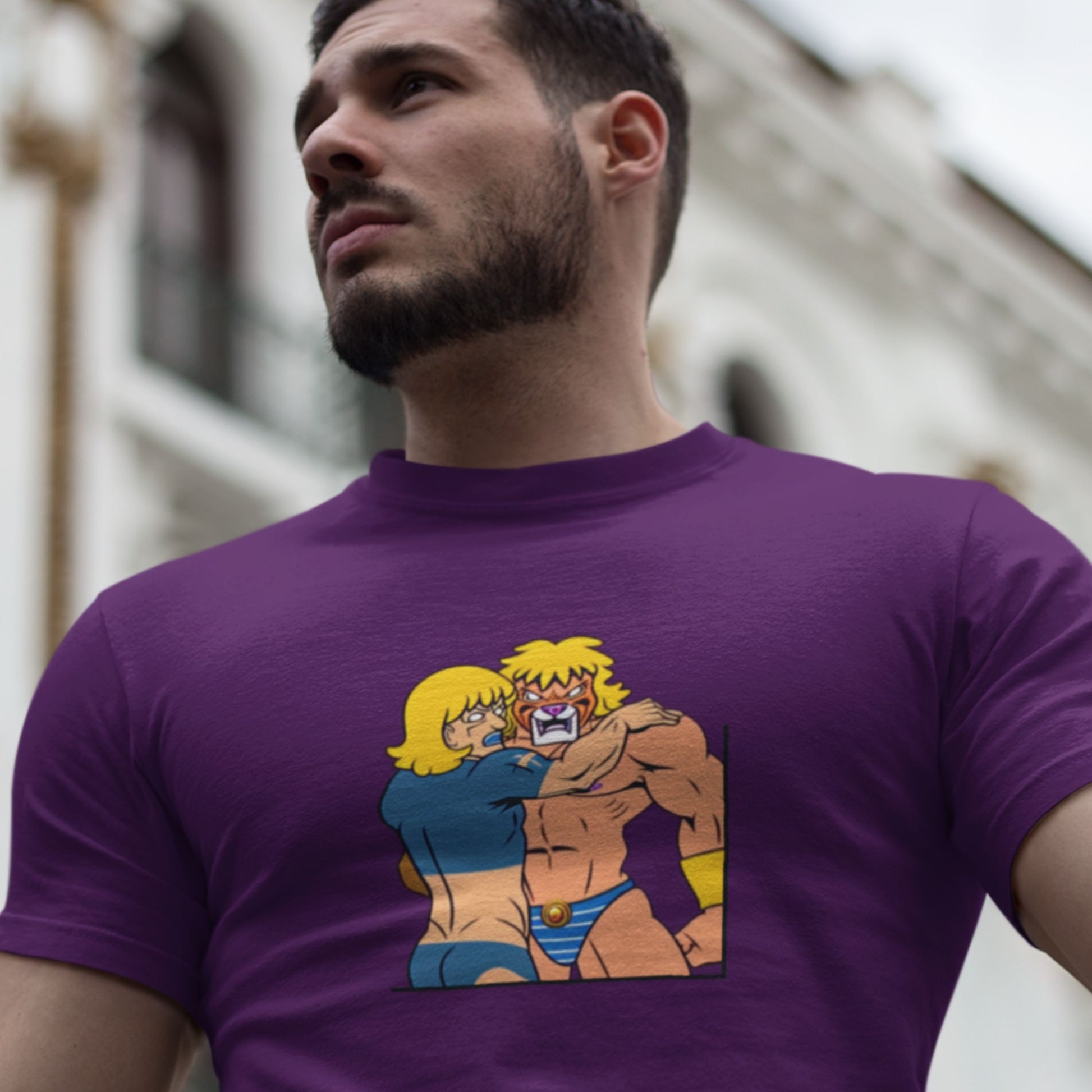 Muscular man wearing a purple t-shirt with a fun, colorful cartoon illustration in the city.