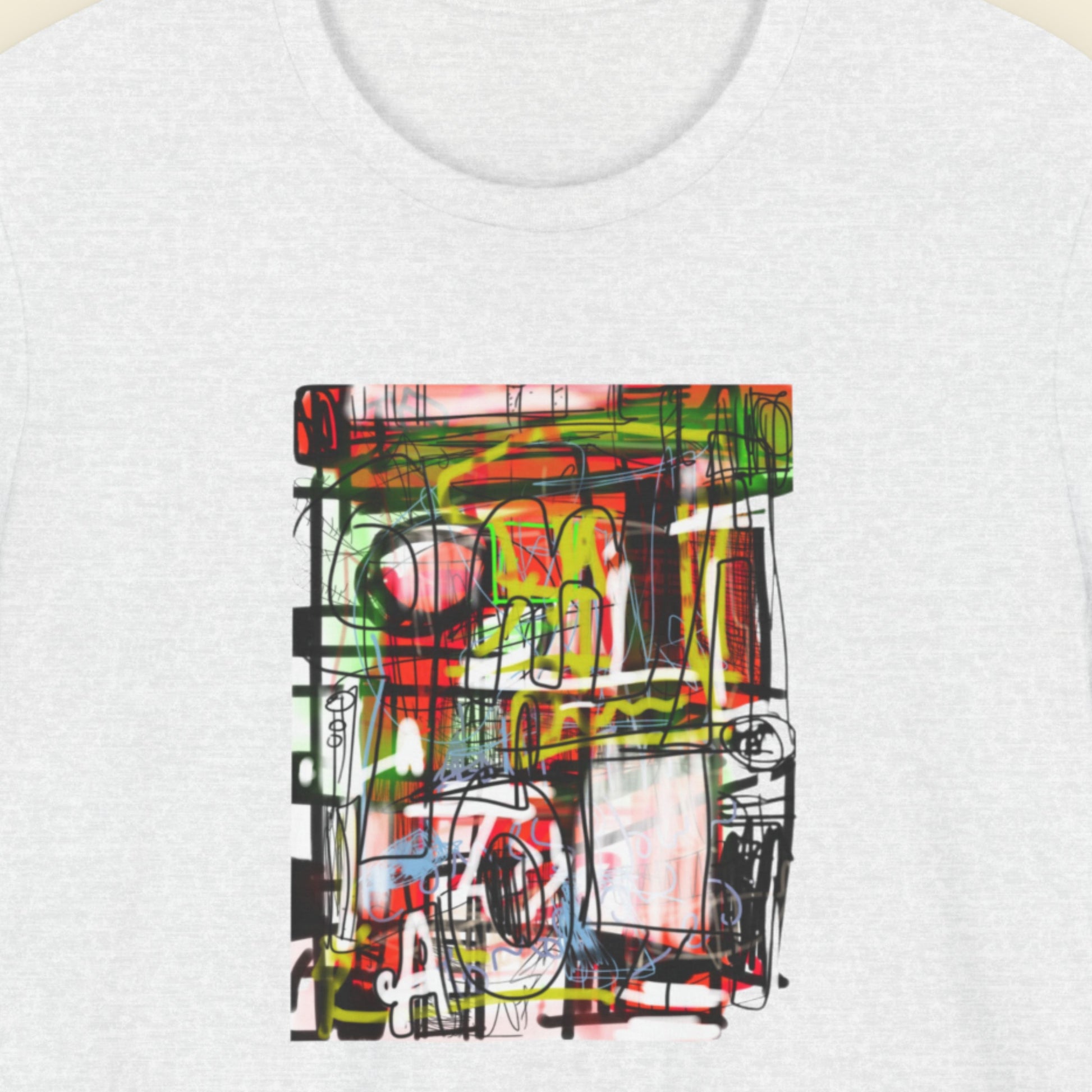 Ash grey t-shirt with a colorful abstract drawing on a beige background.