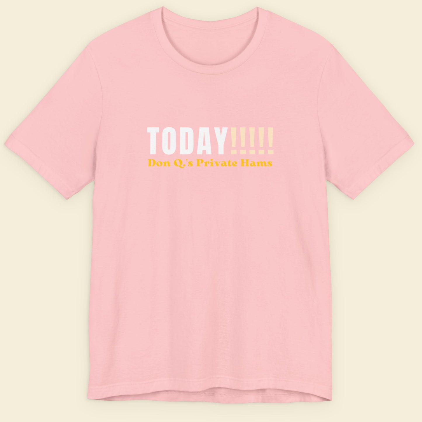 Pink t-shirt with text on a beige background.