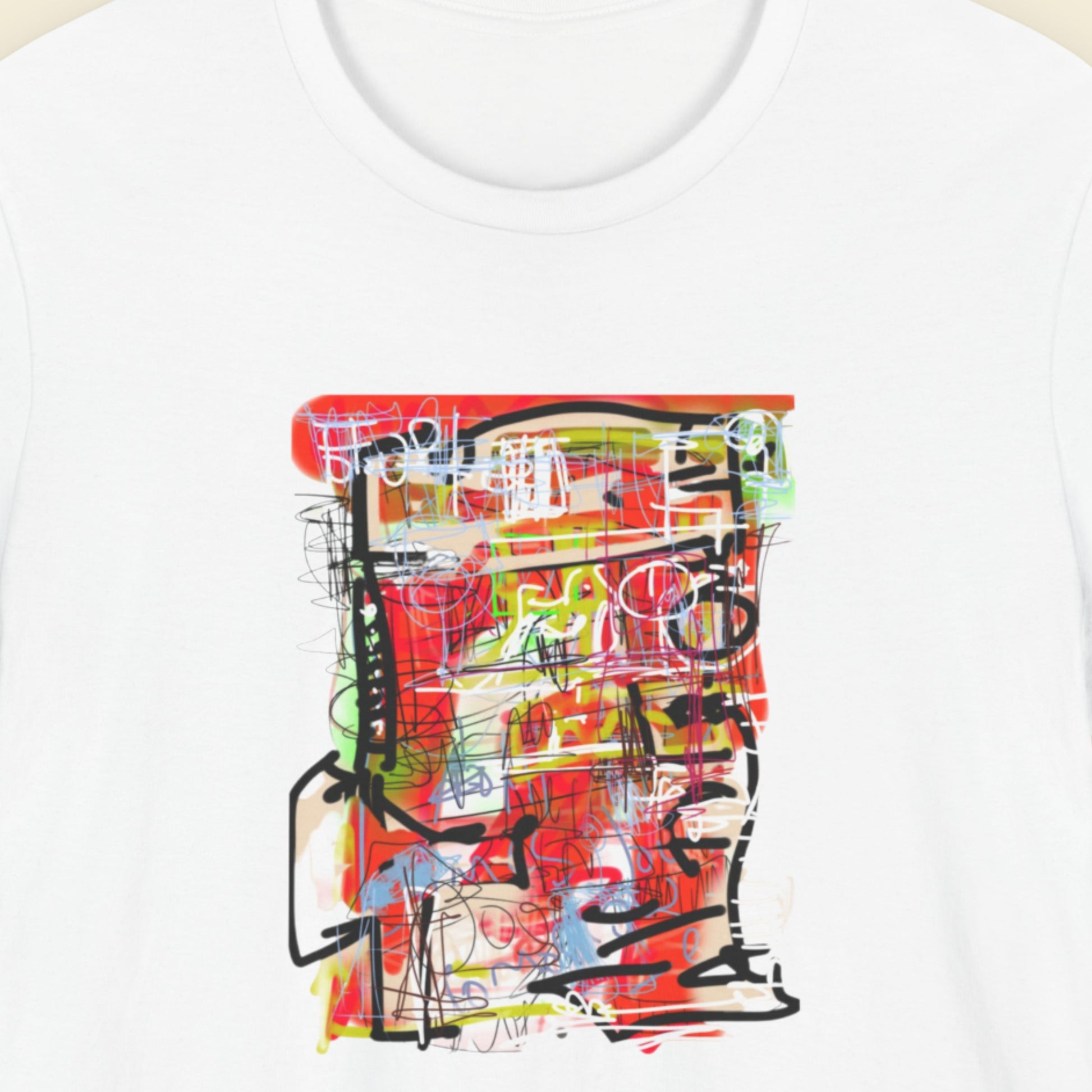 White t-shirt with a colorful abstract drawing on a beige background.