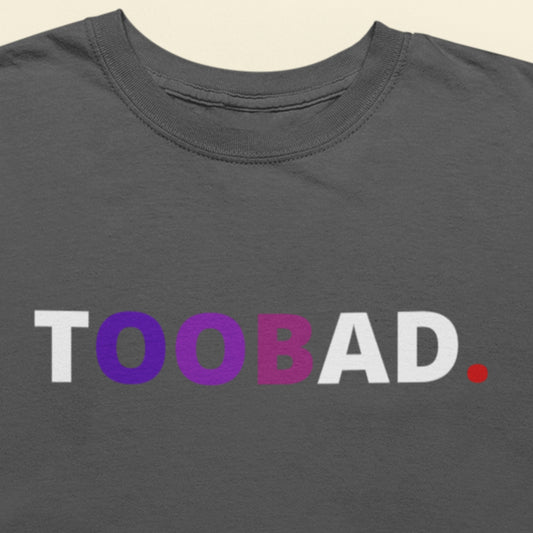 Gray t-shirt with 'TOOBAD.' text in white, purple, and red on a beige background