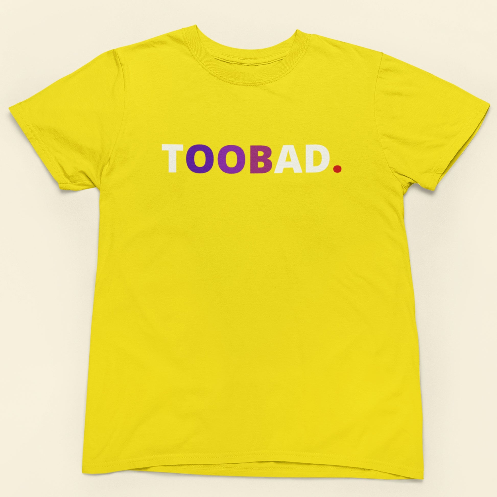 Yellow t-shirt with 'TOOBAD' text in white, purple, and red on a beige background