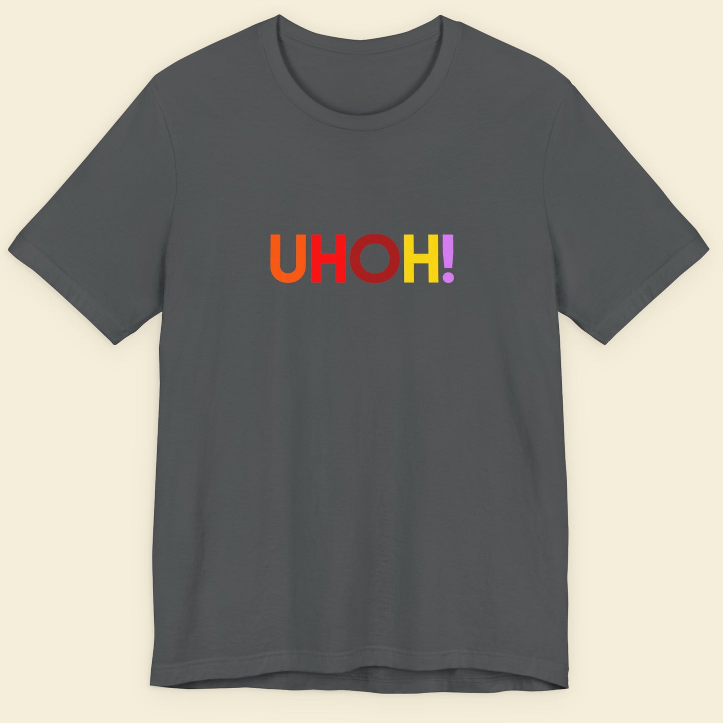 Gray t-shirt with 'UHOH!' text in multicolor on a beige background.