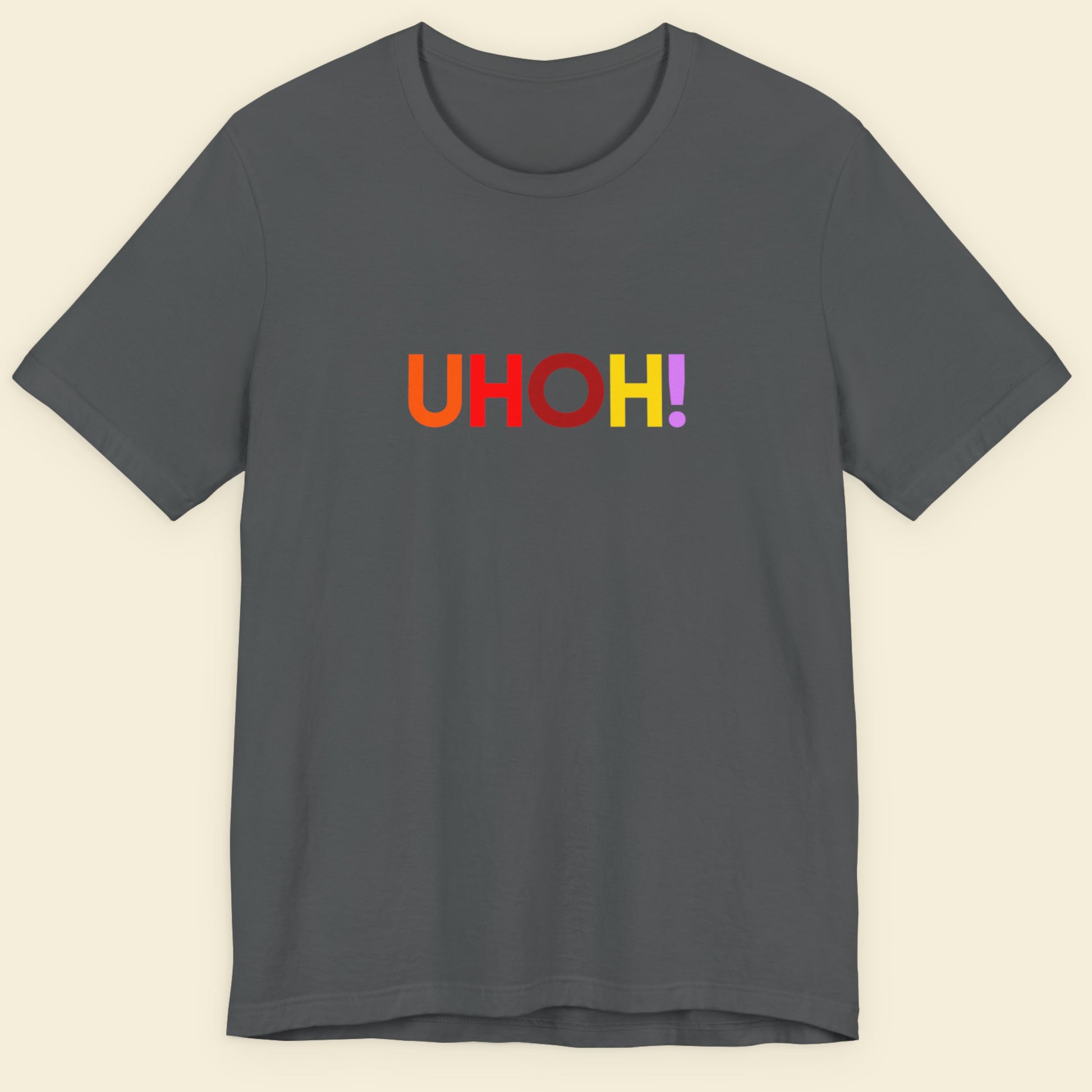 Gray t-shirt with 'UHOH!' text in multicolor on a beige background.