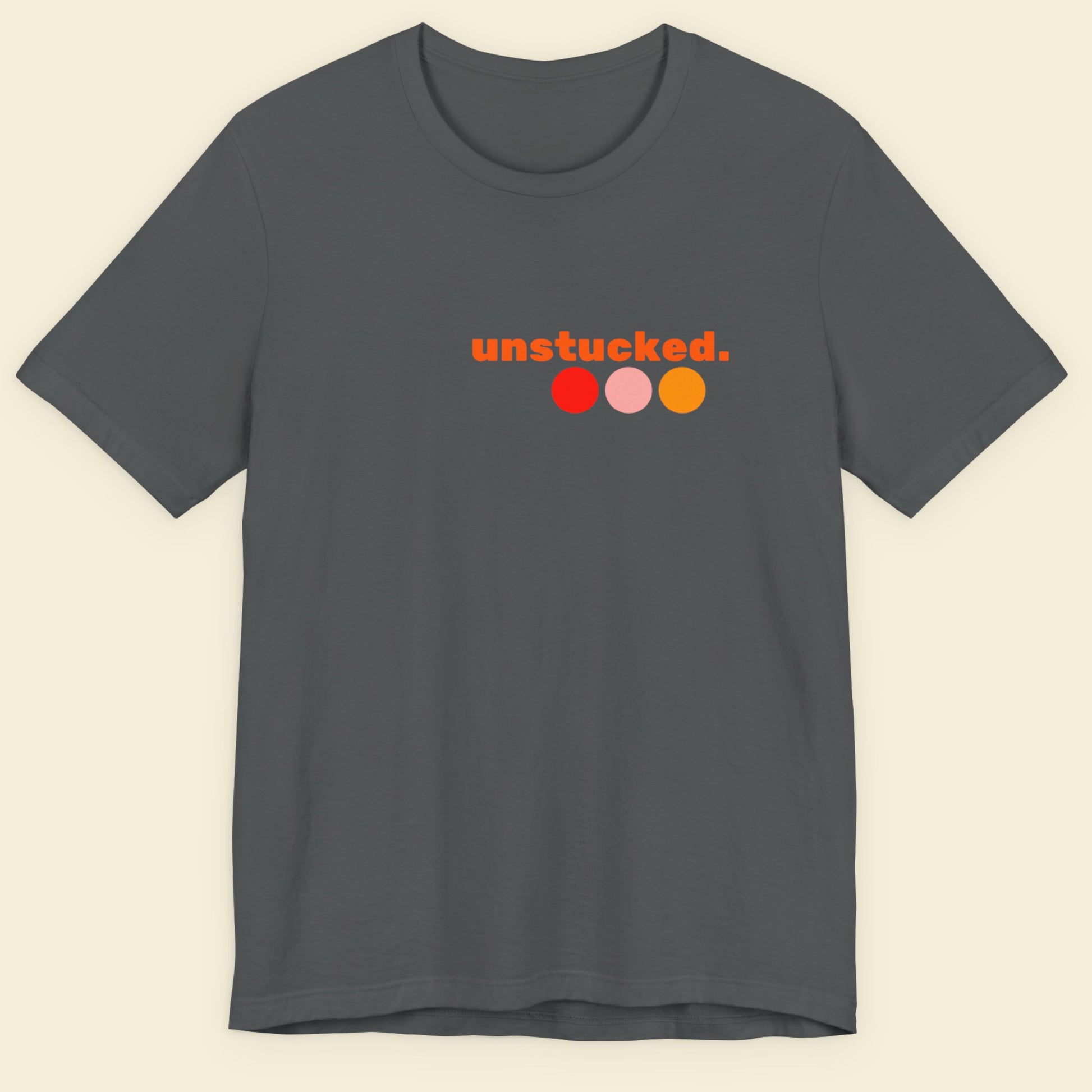 Gray t-shirt with 'unstucked.' logo on a beige background.