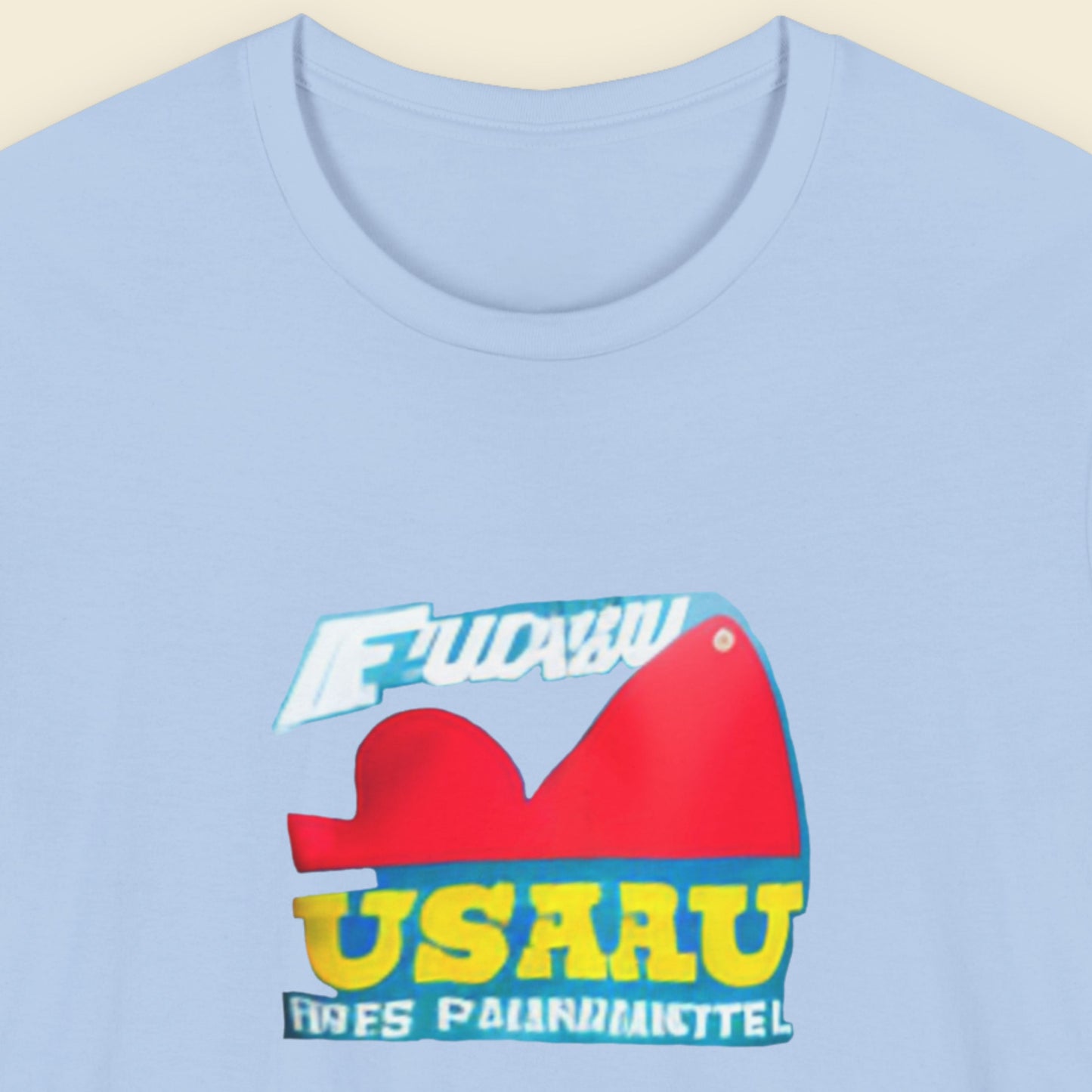 Baby blue t-shirt with a fun, colorful abstract cartoon illustration on a beige background.