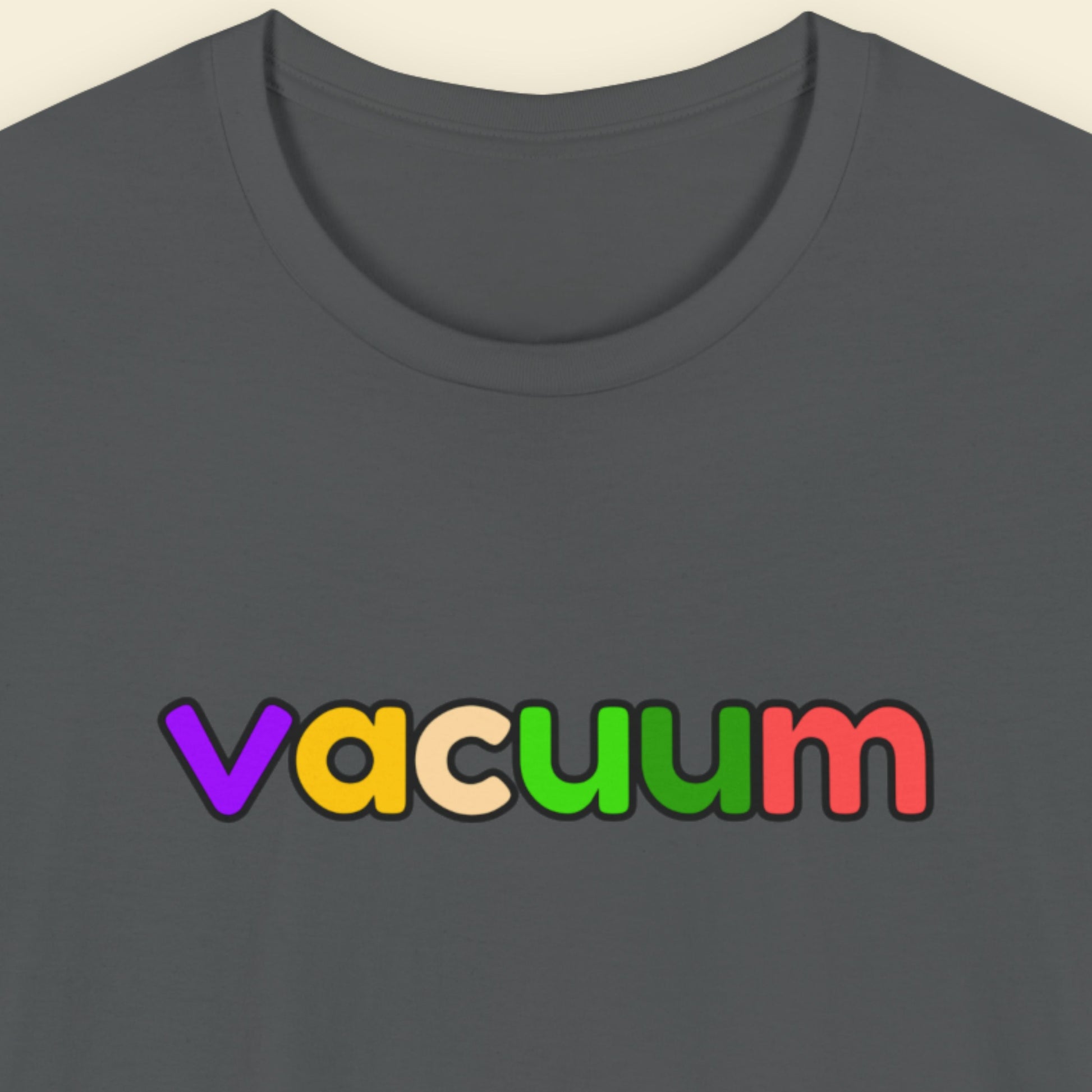 Grey t-shirt with humorous colorful text on a beige background.