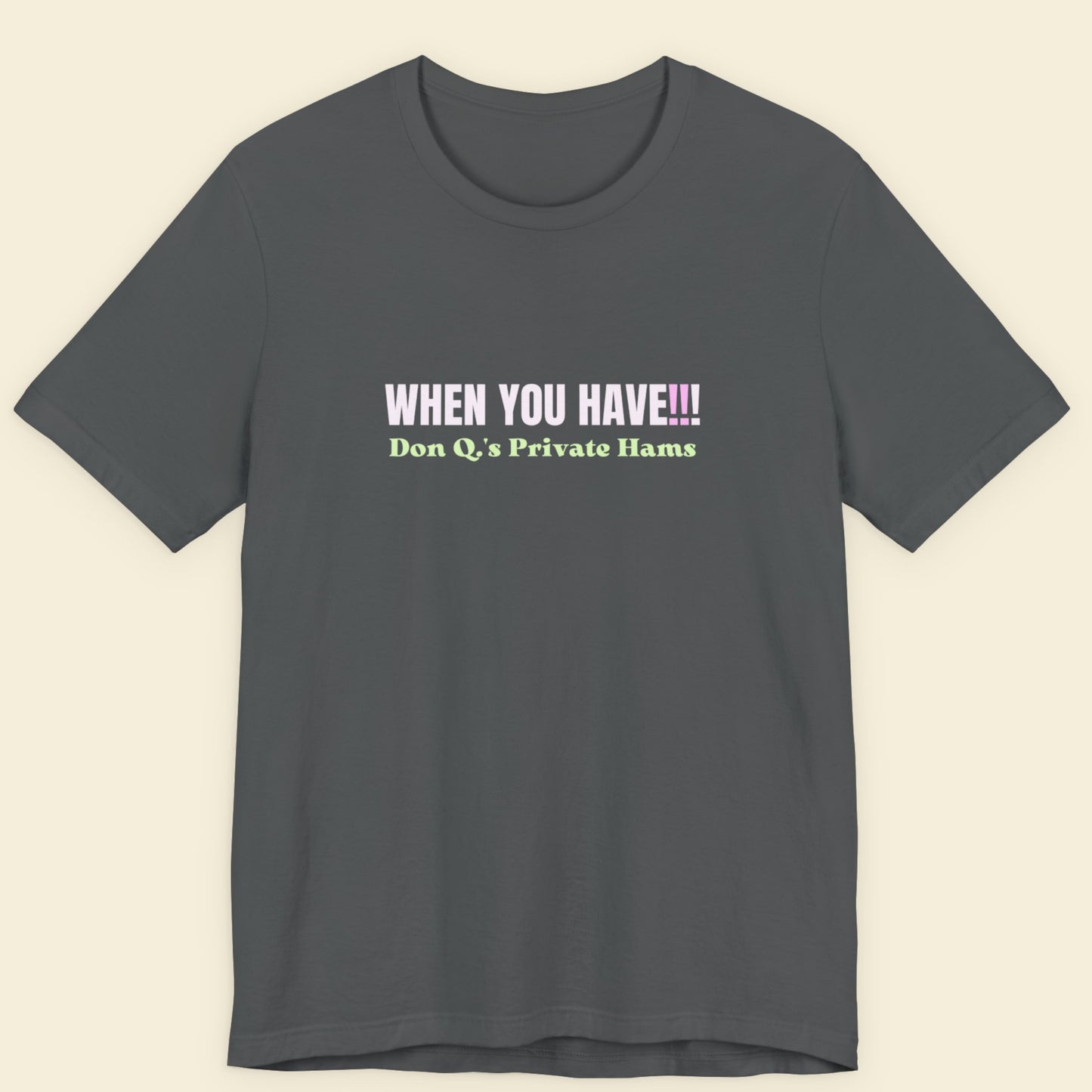 Grey t-shirt with colorful nonsensical text on a beige background.