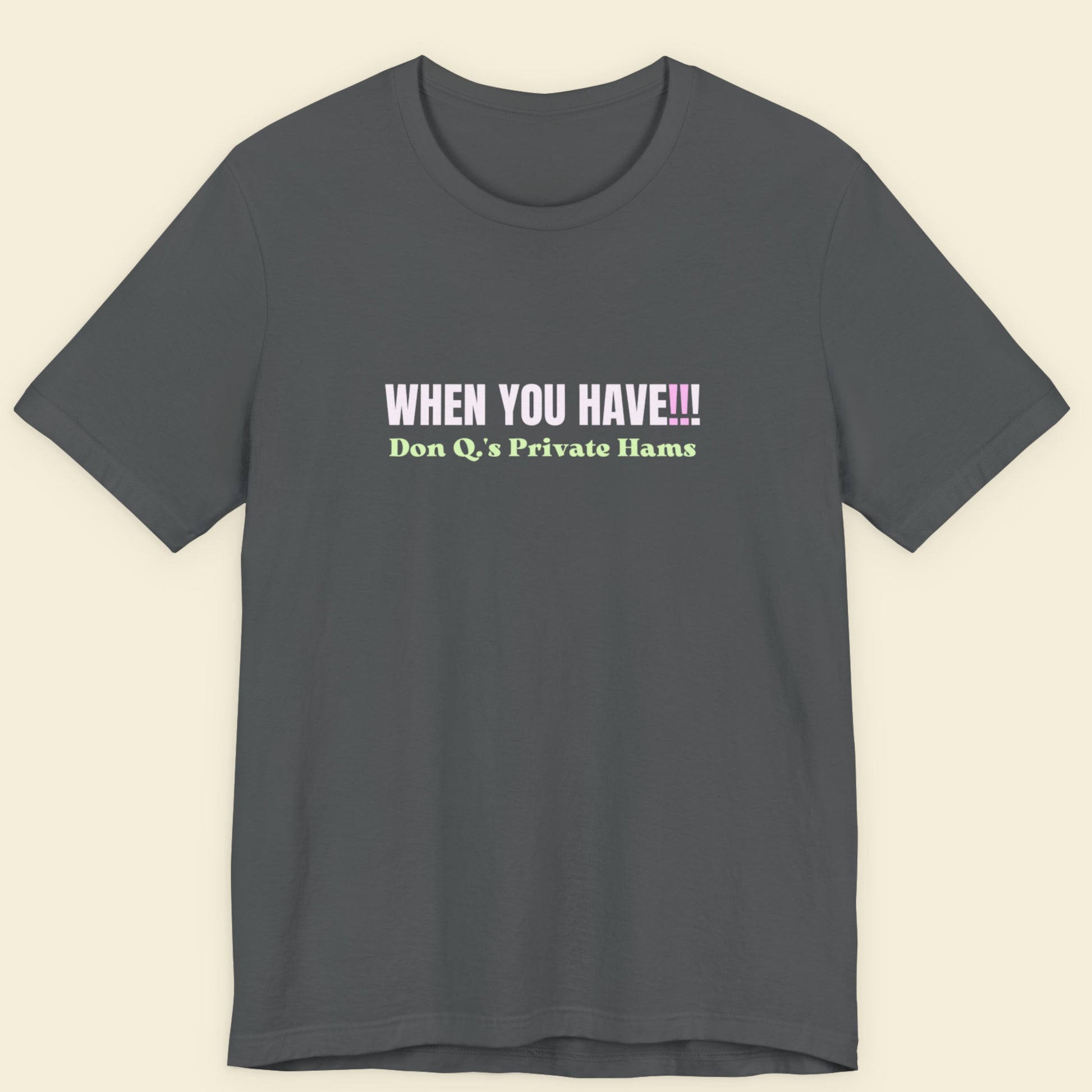 Grey t-shirt with colorful nonsensical text on a beige background.