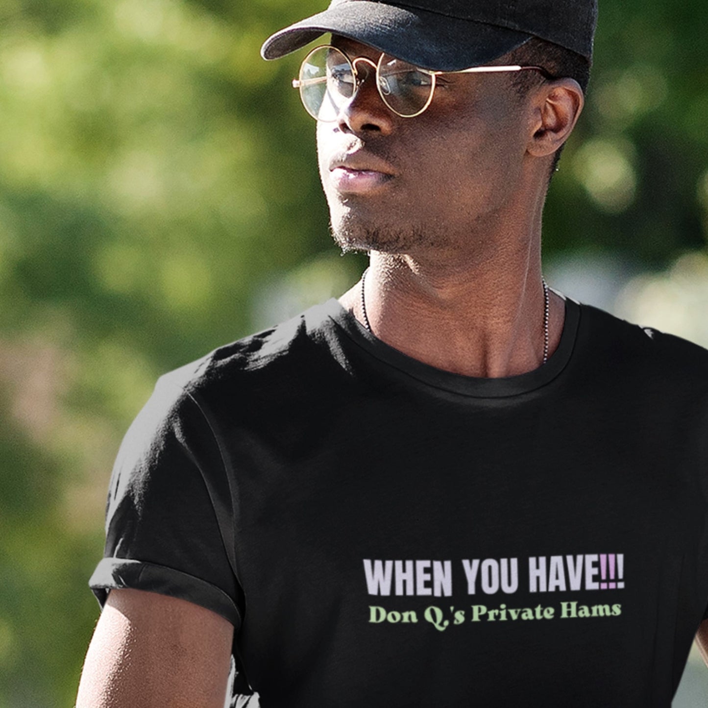 Man wearing a black t-shirt with colorful nonsensical text outside.