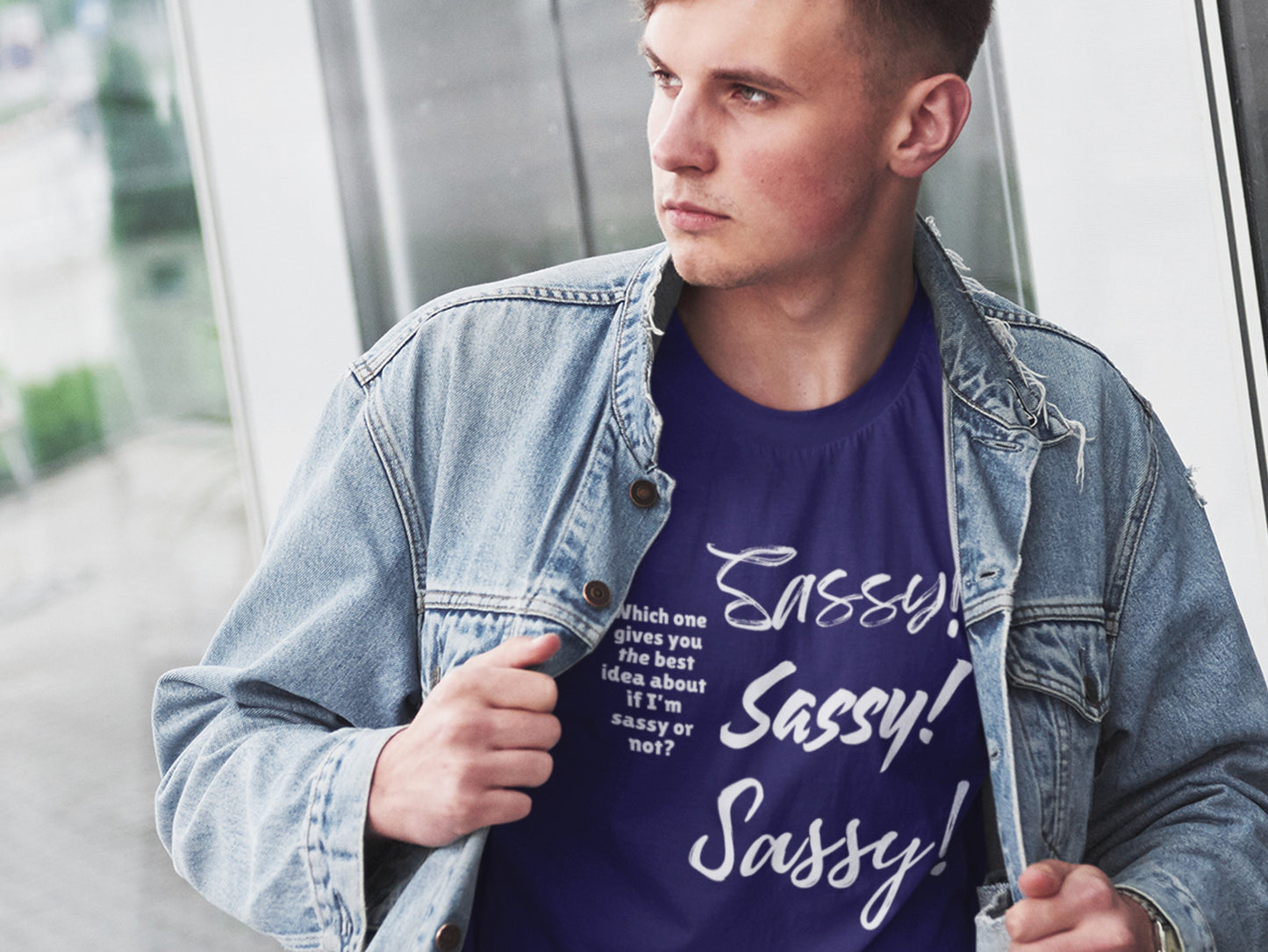 Person wearing a denim jacket and a t-shirt with 'Sassy' text.
