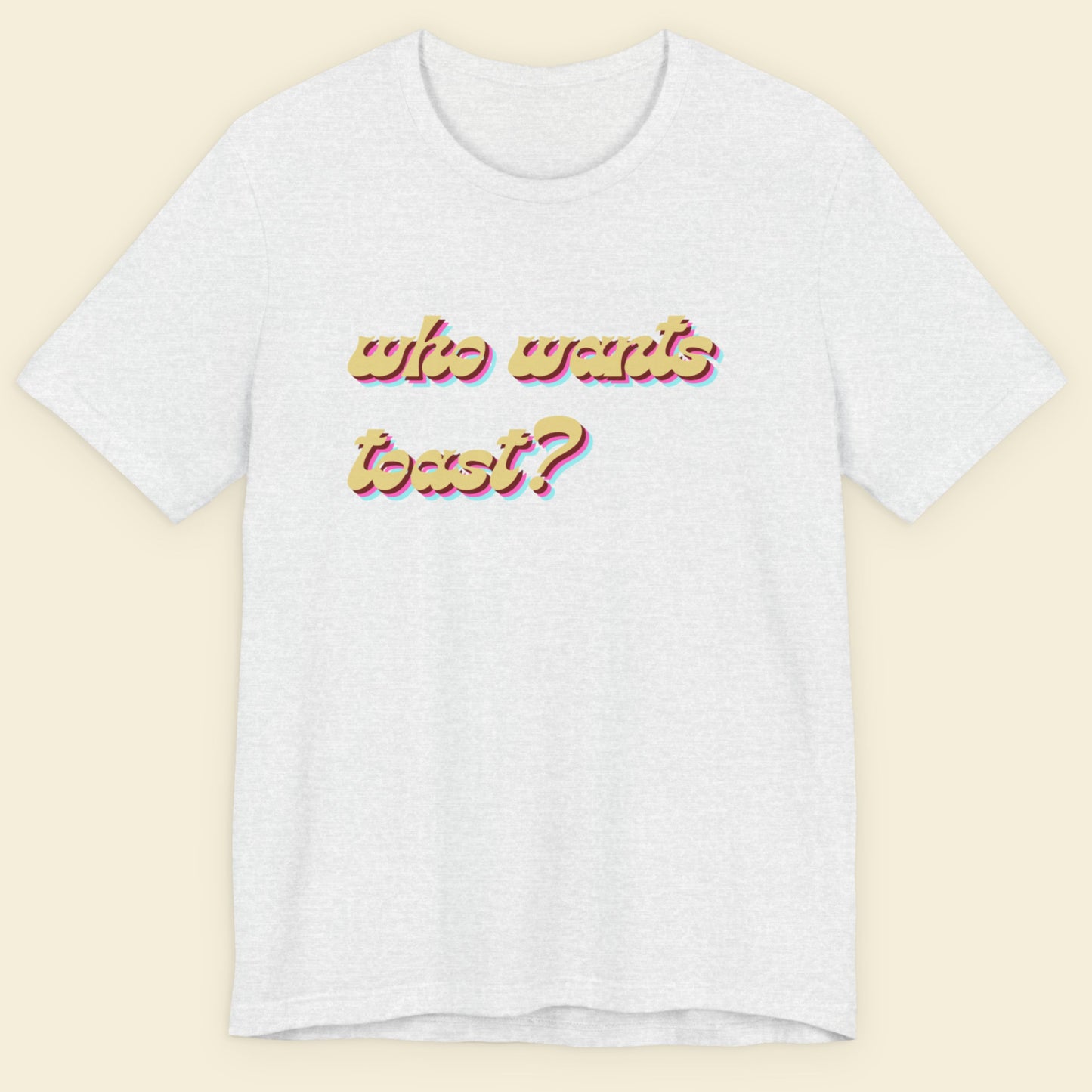 Ash grey t-shirt with colorful text on a beige background.