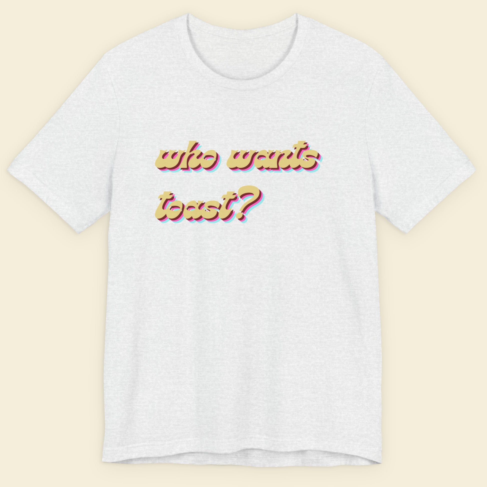Ash grey t-shirt with colorful text on a beige background.