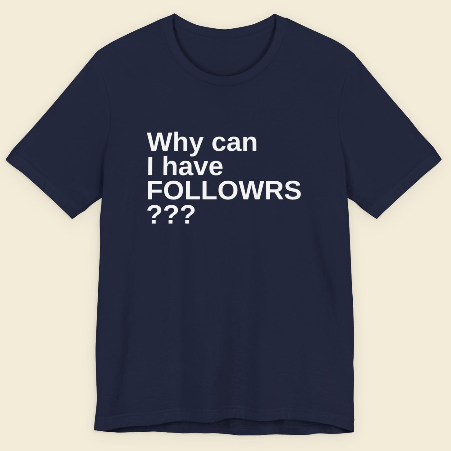 Navy blue t-shirt with white text on a beige background.