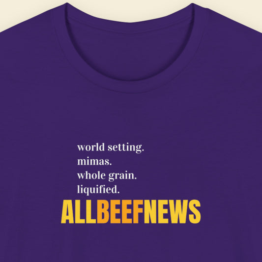 Navy blue t-shirt with humorous colorful text on a beige background.