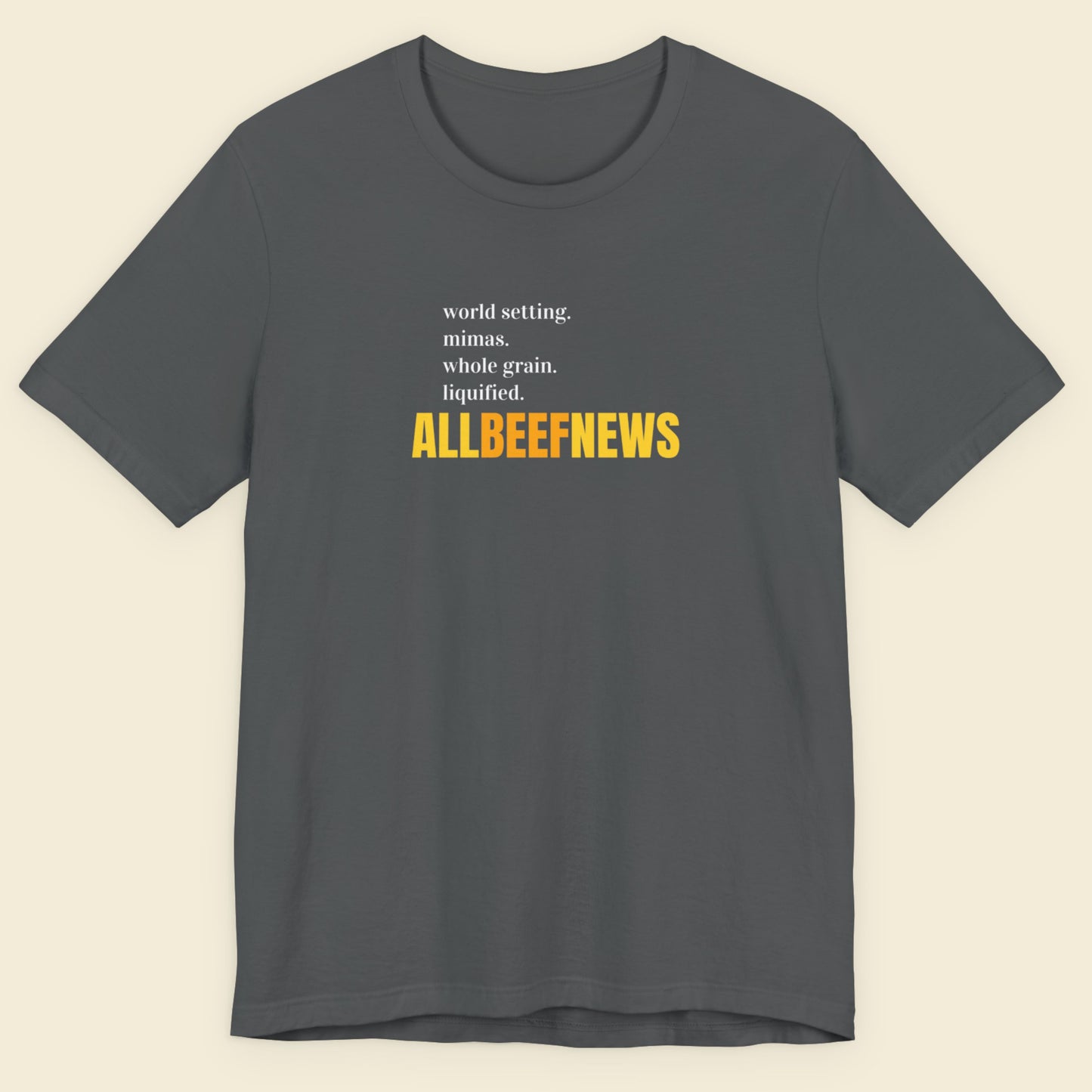 Grey t-shirt with humorous colorful text on a beige background.