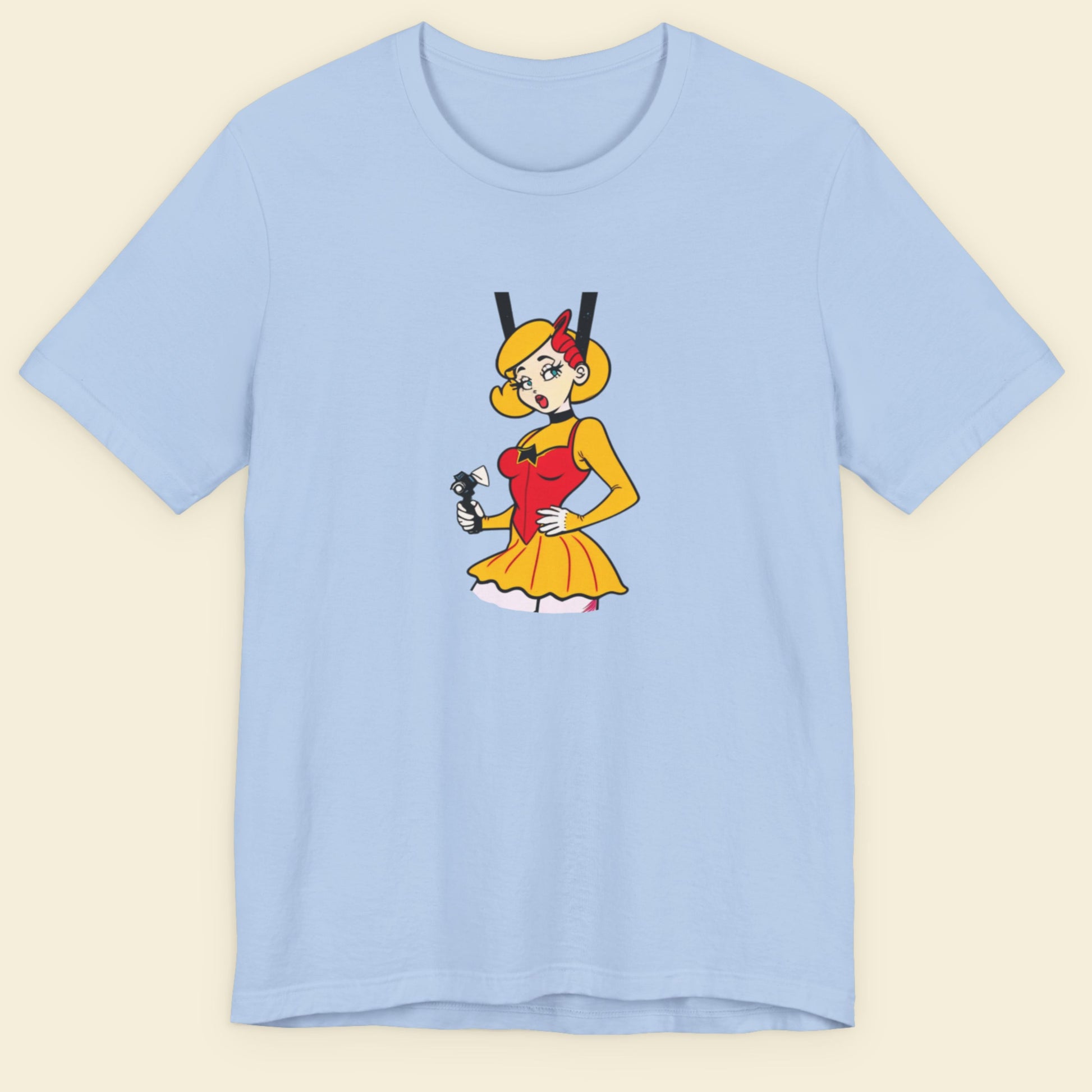Baby blue t-shirt with a fun, colorful cartoon illustration on a beige background.