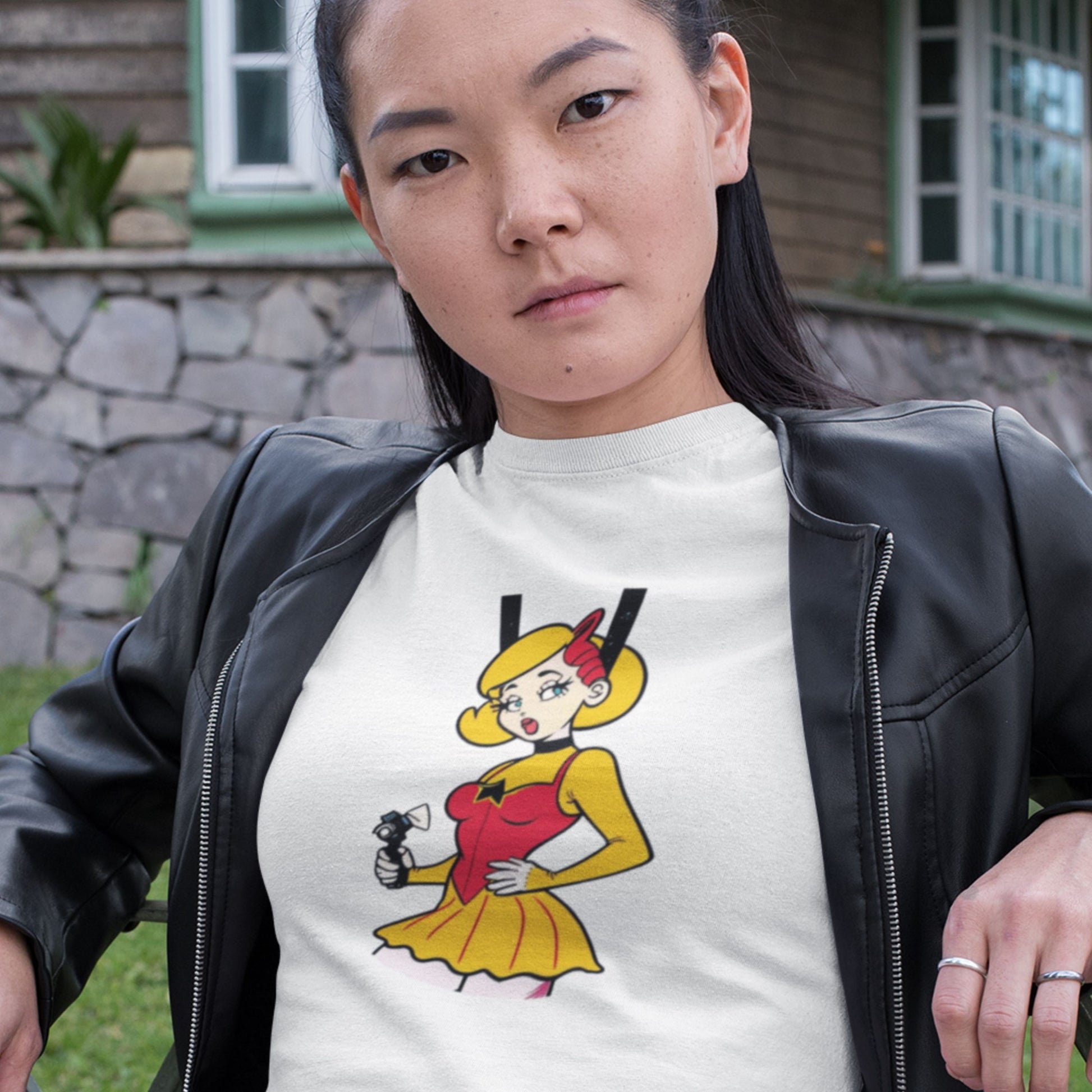 Attitude woman wearing a white t-shirt with a fun, colorful cartoon illustration in front of your house.