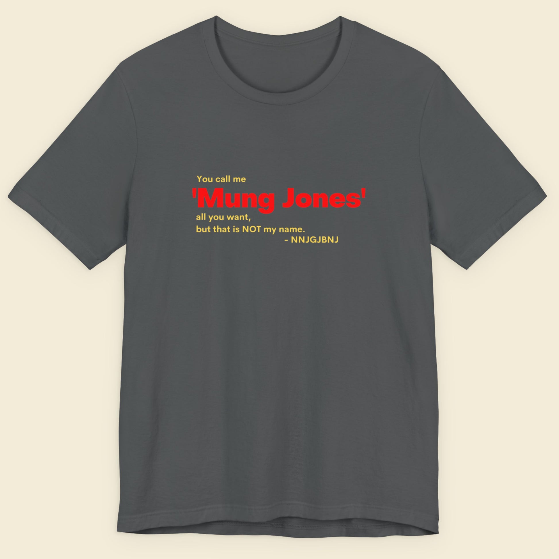 Gray t-shirt with red and yellow text on a beige background.