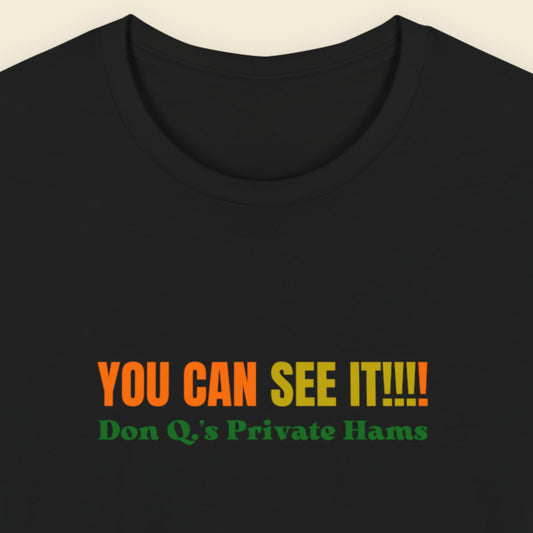 Black t-shirt with multicolored 'you can see it!!!!' text on a beige background.