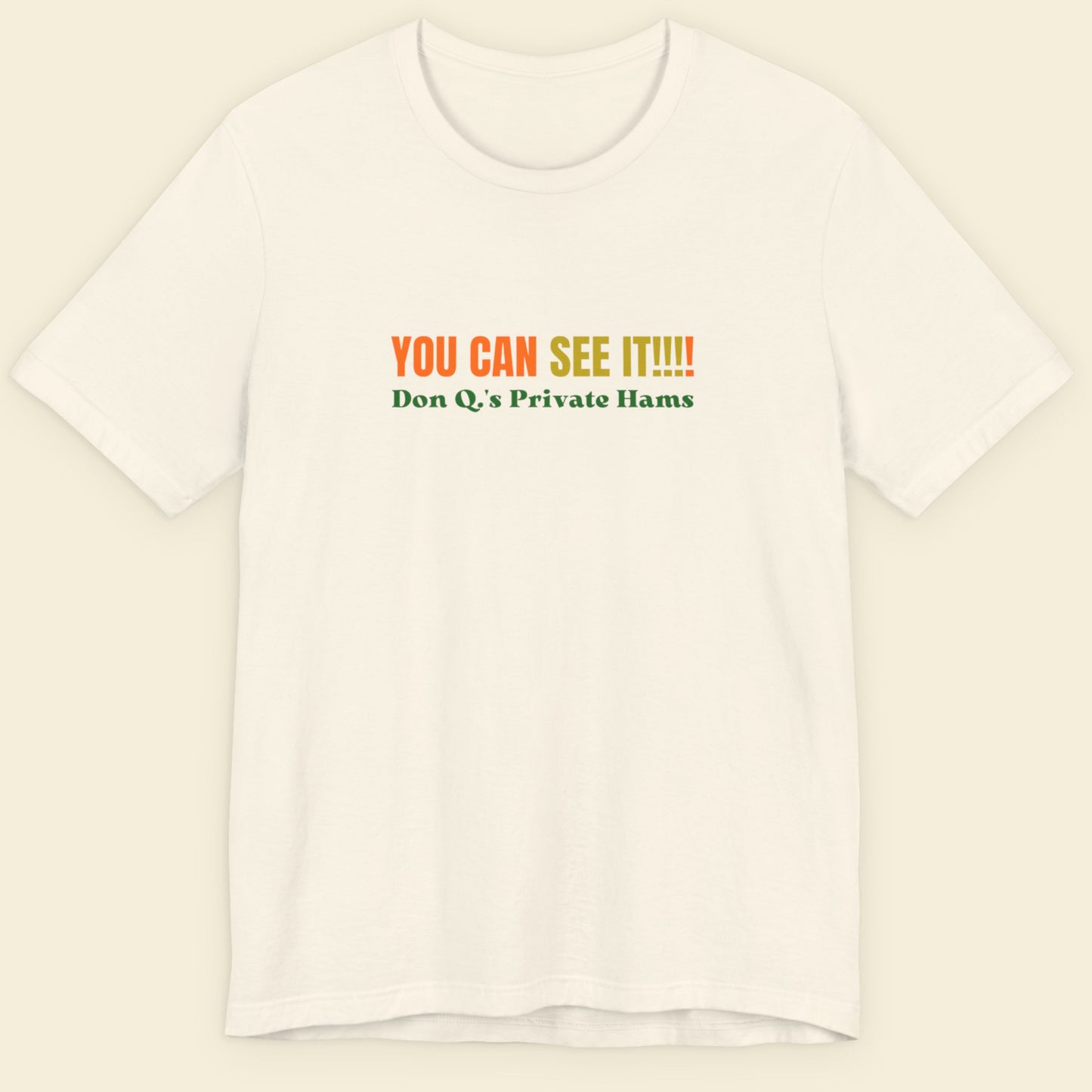 Off-white t-shirt with multicolored 'you can see it!!!!' text on a beige background.