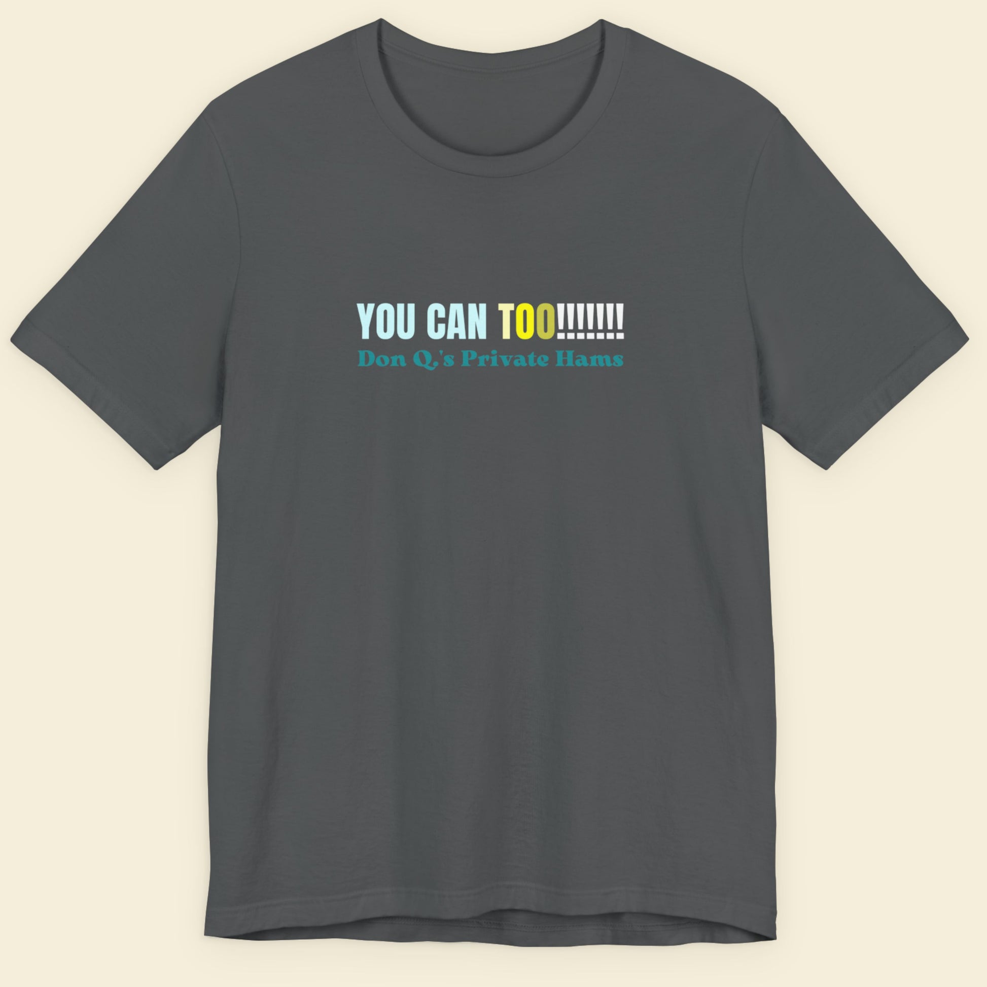 Gray t-shirt with colorful text on a beige background.
