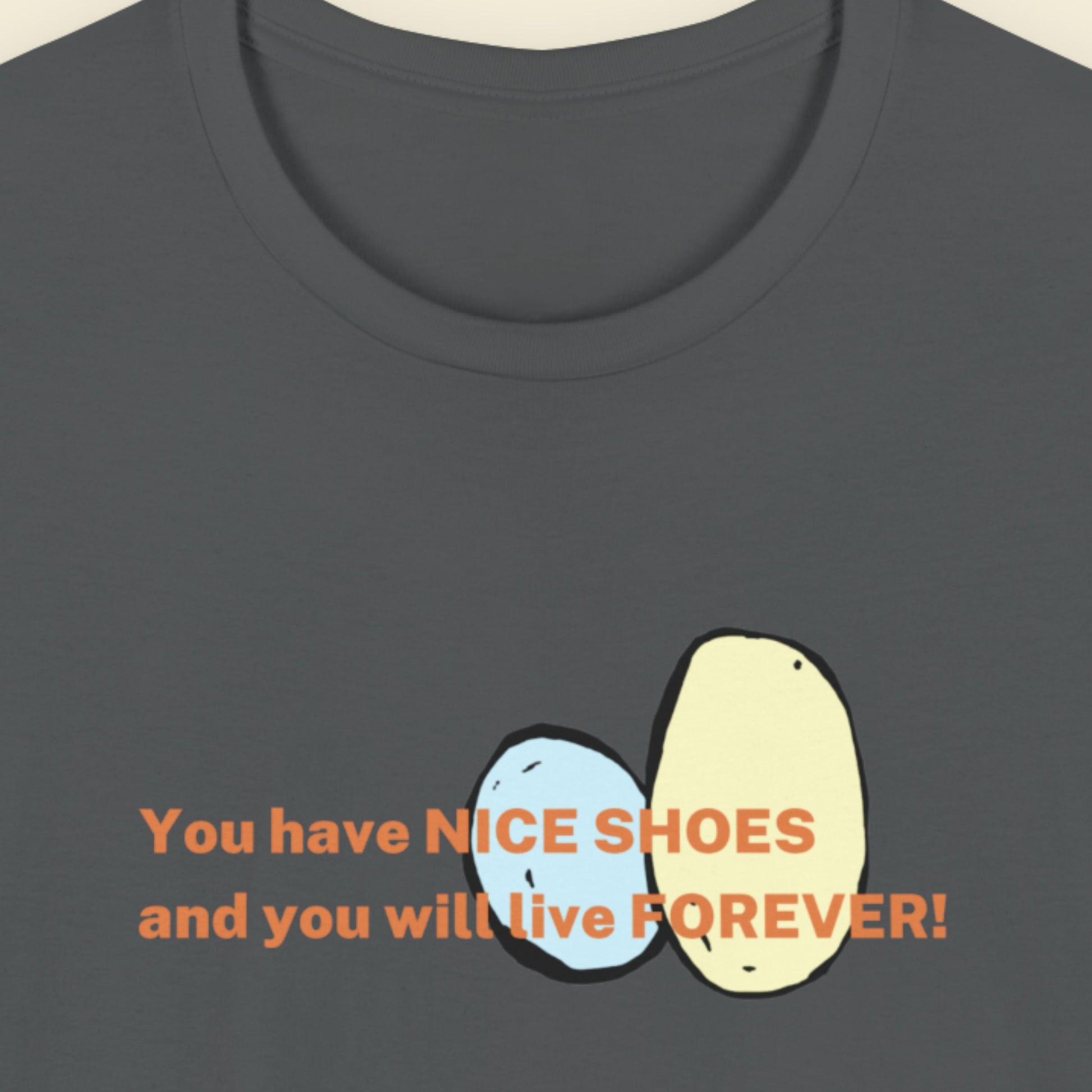 Dark gray t-shirt with a cartoon drawing and text on a beige background.