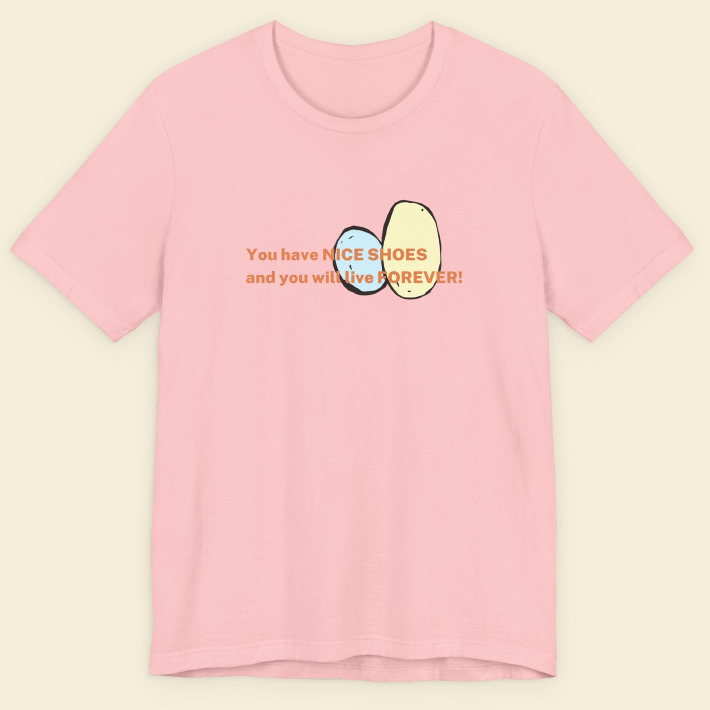 Pink t-shirt with text and graphics on a beige background.