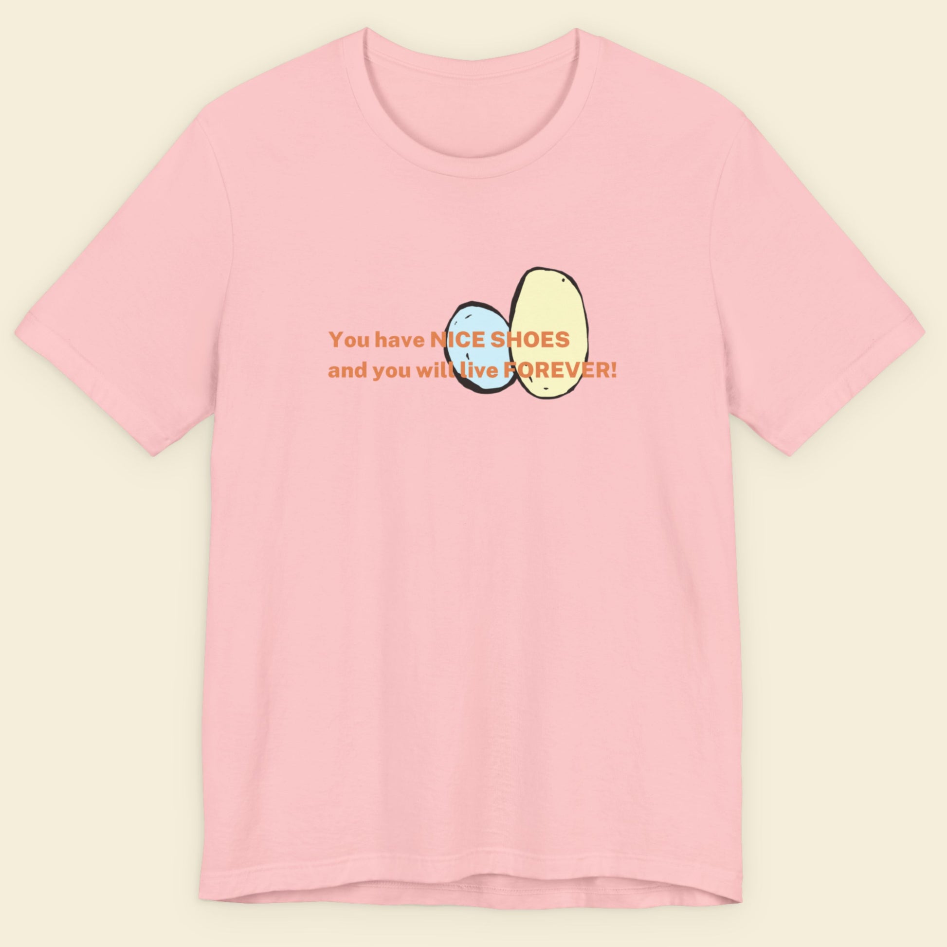 Pink t-shirt with text and graphics on a beige background.