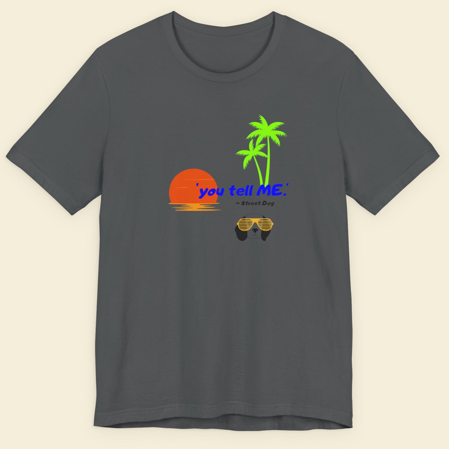 Gray t-shirt with a graphic design featuring a sunset, palm trees, and sunglasses on a beige background.