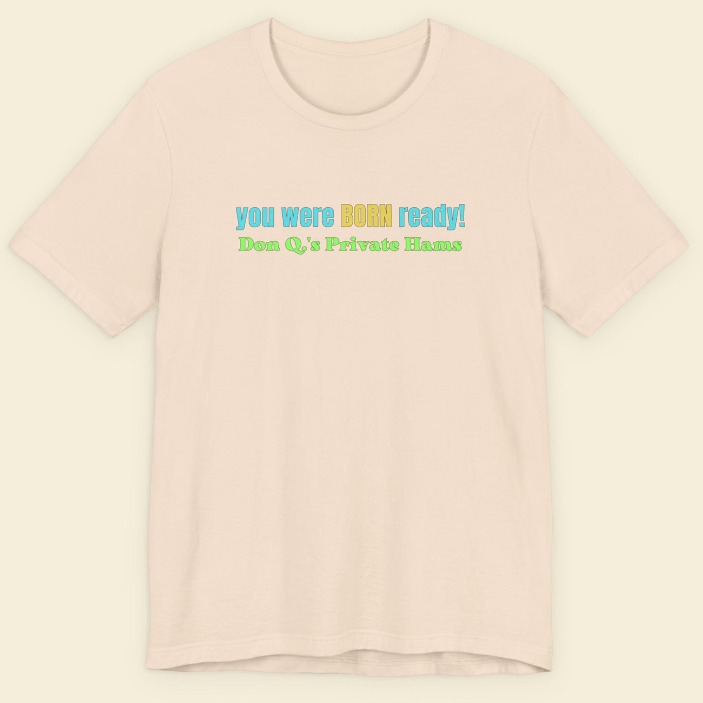 Beige t-shirt with colorful text on a light beige background.