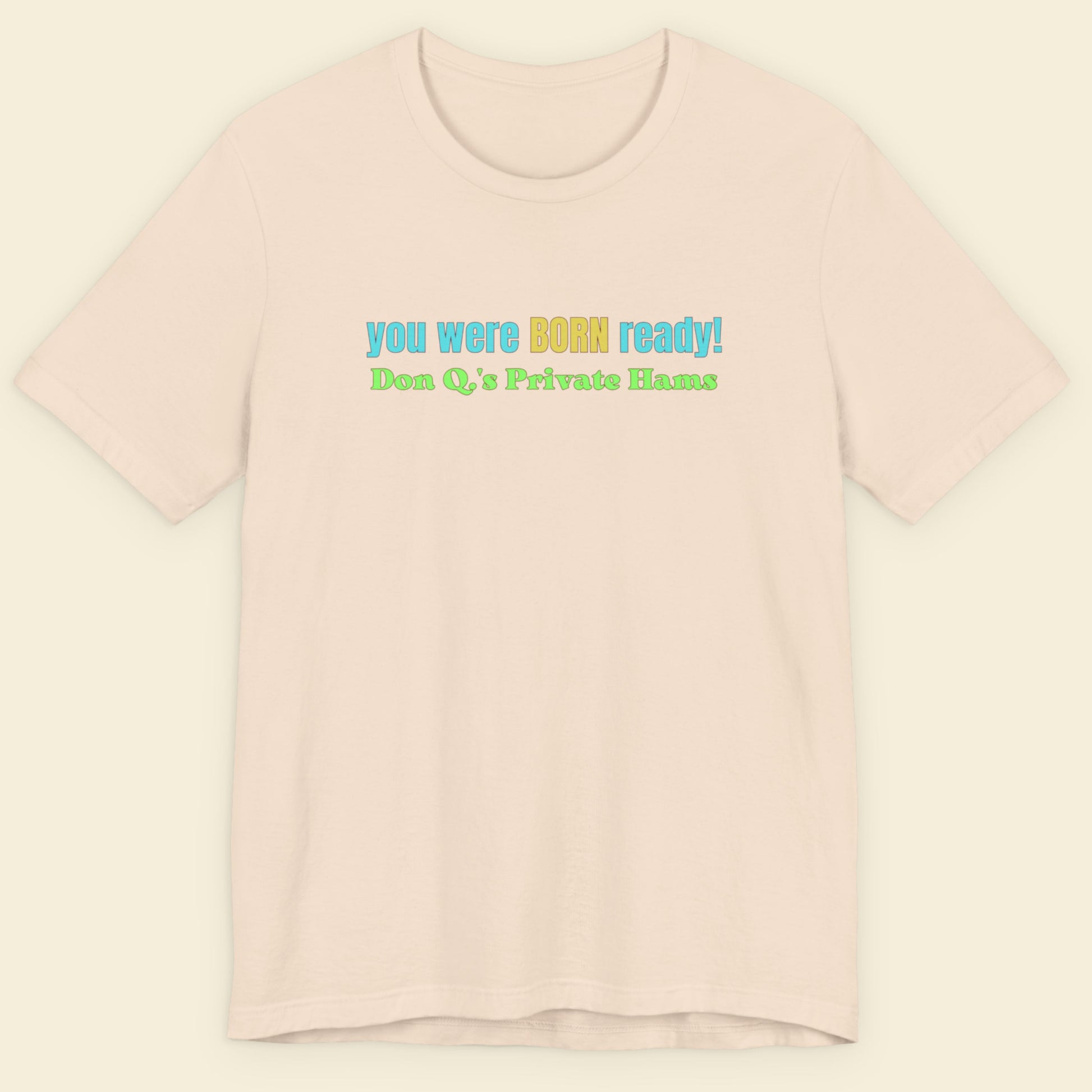 Beige t-shirt with colorful text on a light beige background.