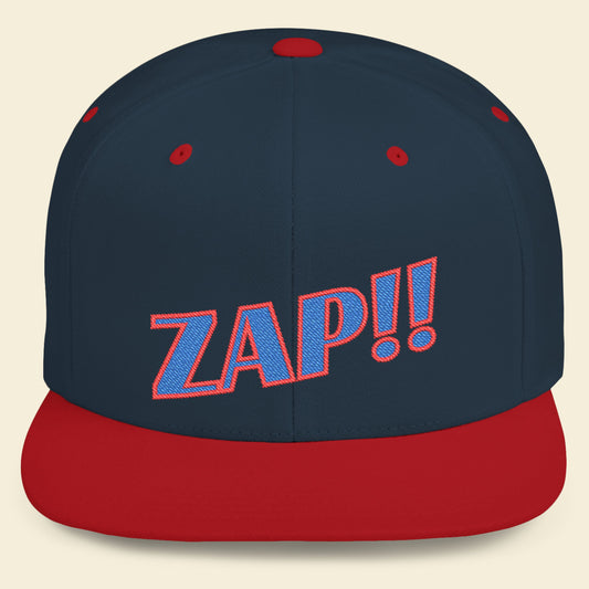 Navy and red cap with 'ZAP!!' text on a beige background.