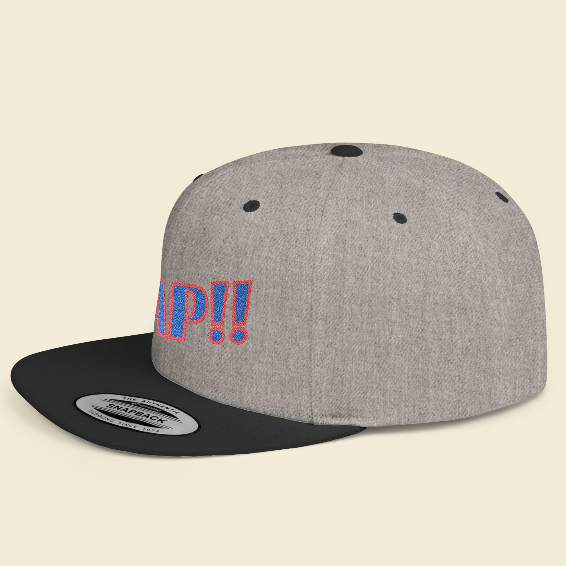 Gray cap with black brim and colorful text on a beige background.