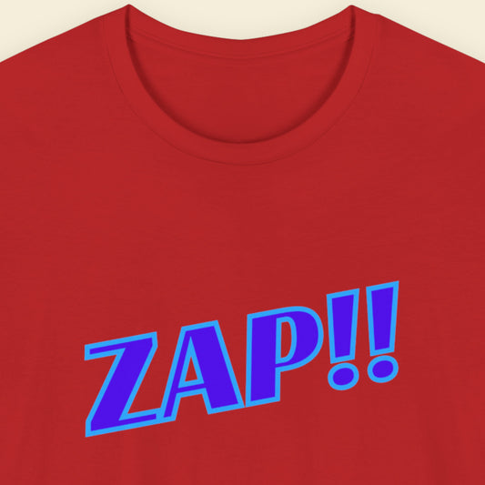 Red t-shirt with blue 'ZAP!!' text on a beige background.