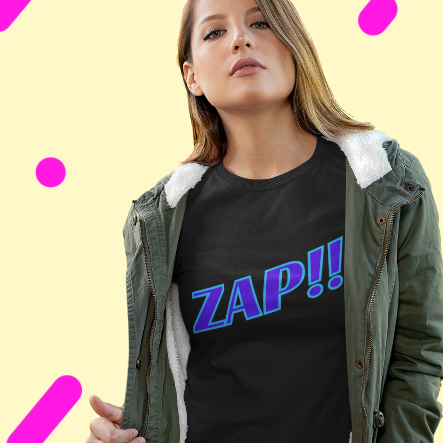 Woman wearing a black t-shirt with 'ZAP!!' text and a green jacket on a yellow background with pink polka dots.